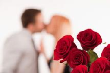 couple kissing with roses